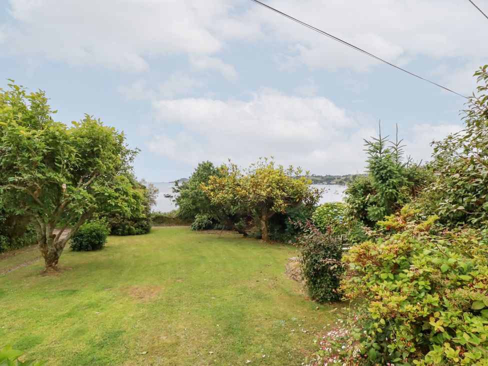 A garden with trees and grass at Nanvivian in Feock near Truro