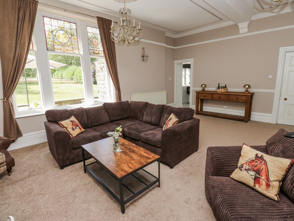 A living room with a coffee table and sofa at Cold Spring House in Cullingworth