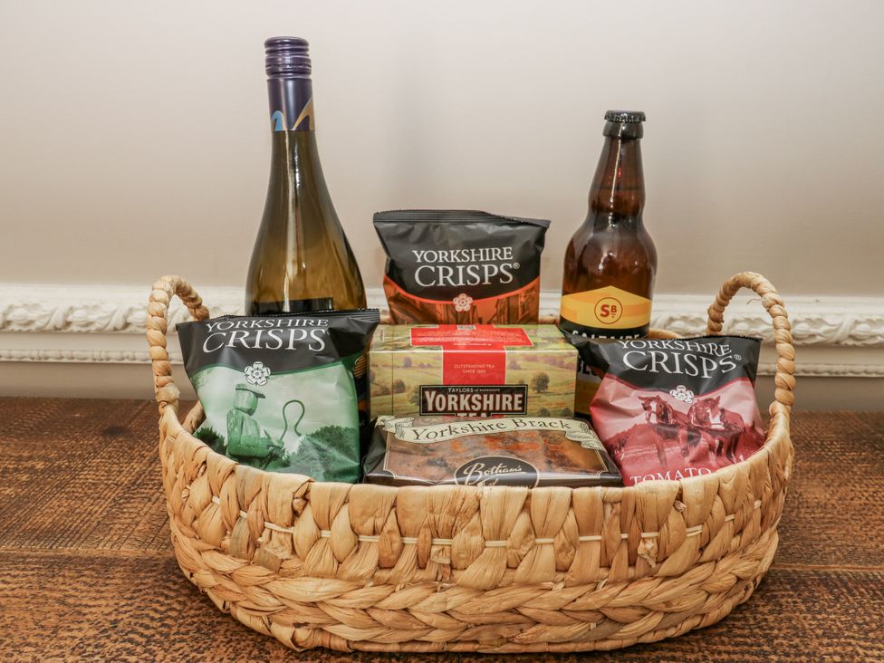 A basket with crisps, Yorkshire brack, wine, and beer at Cold Spring House in Cullingworth