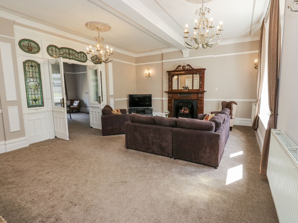 A living room featuring a sofa and television at Cold Spring House in Cullingworth