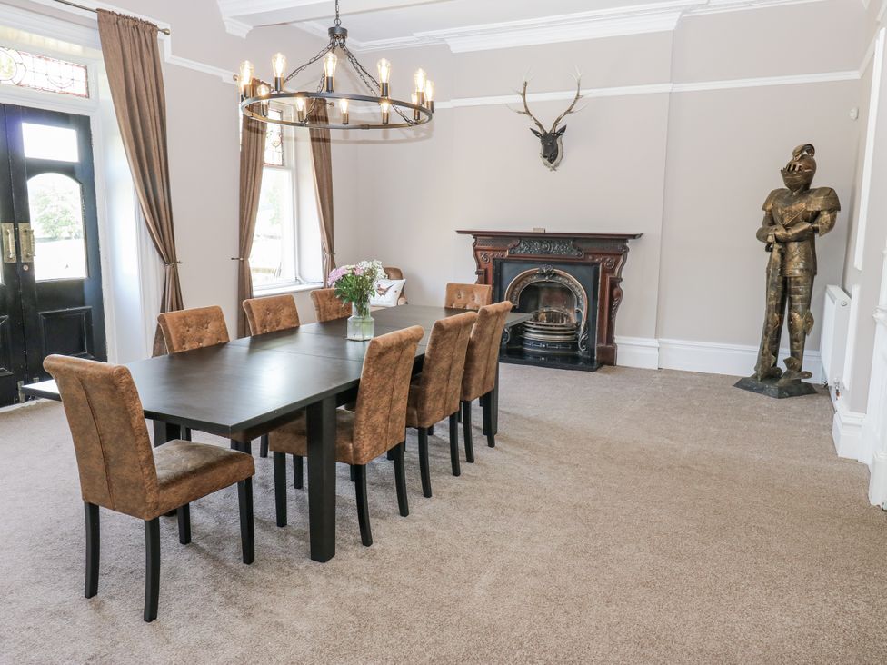 A dining room with a table and chairs at Cold Spring House in Cullingworth