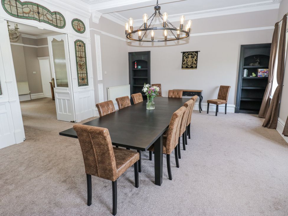 A dining room with a large table and chairs at Cold Spring House in Cullingworth