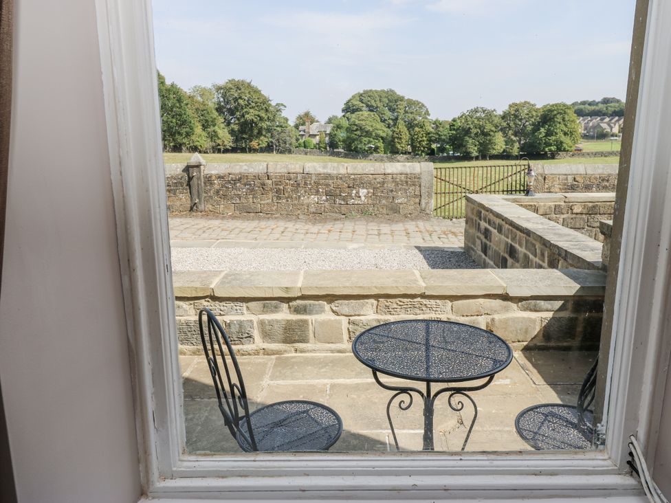 A patio with a table and two chairs at Cold Spring House in Cullingworth