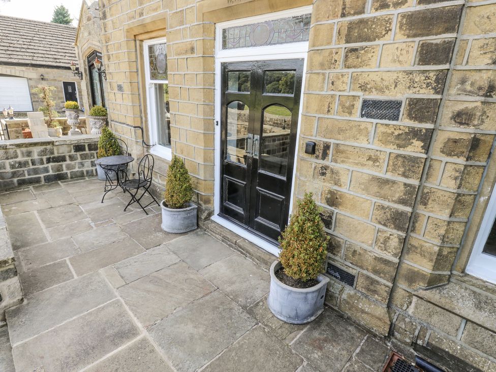 An outdoor area with a table and chair at Cold Spring House in Cullingworth