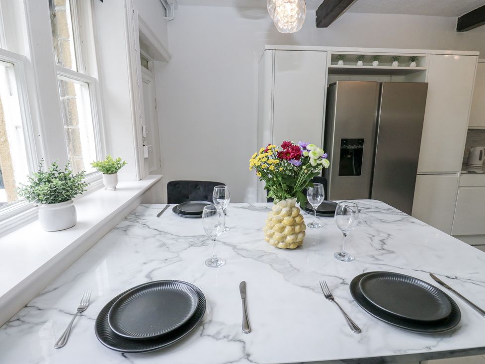 A kitchen with a marble table and flower vase at Cold Spring House in Cullingworth