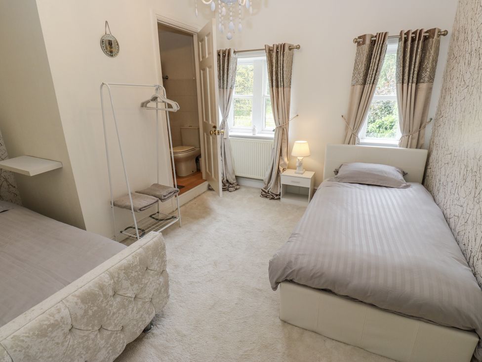A bedroom with two beds and a window at Cold Spring House in Cullingworth