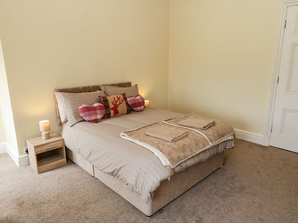 A bedroom with a bed and bedside table at Cold Spring House in Cullingworth