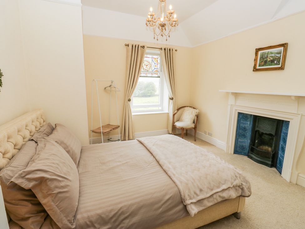A bedroom with a bed and window at Cold Spring House in Cullingworth