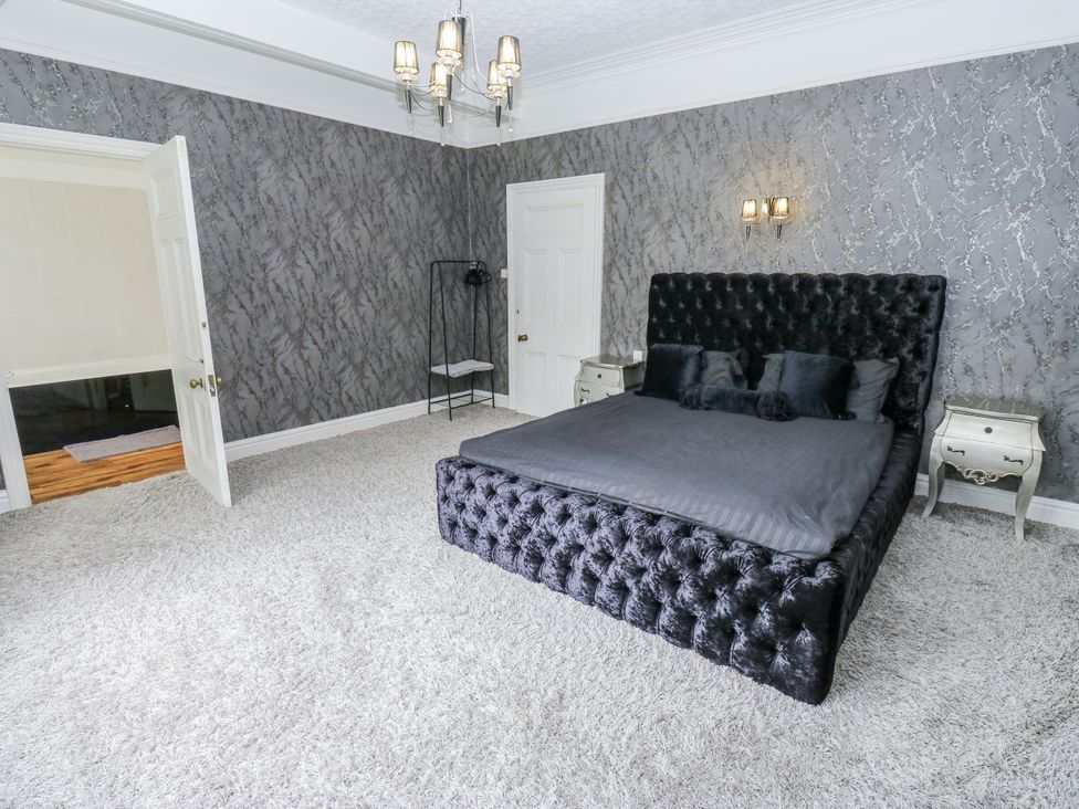 A bedroom with a bed and nightstands at Cold Spring House in Cullingworth