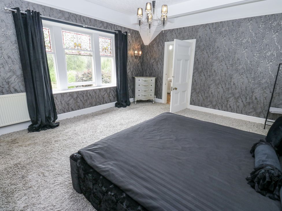 A bedroom with a bed and dresser at Cold Spring House in Cullingworth