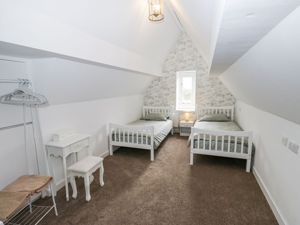 A bedroom with two beds and a window at Cold Spring House in Cullingworth