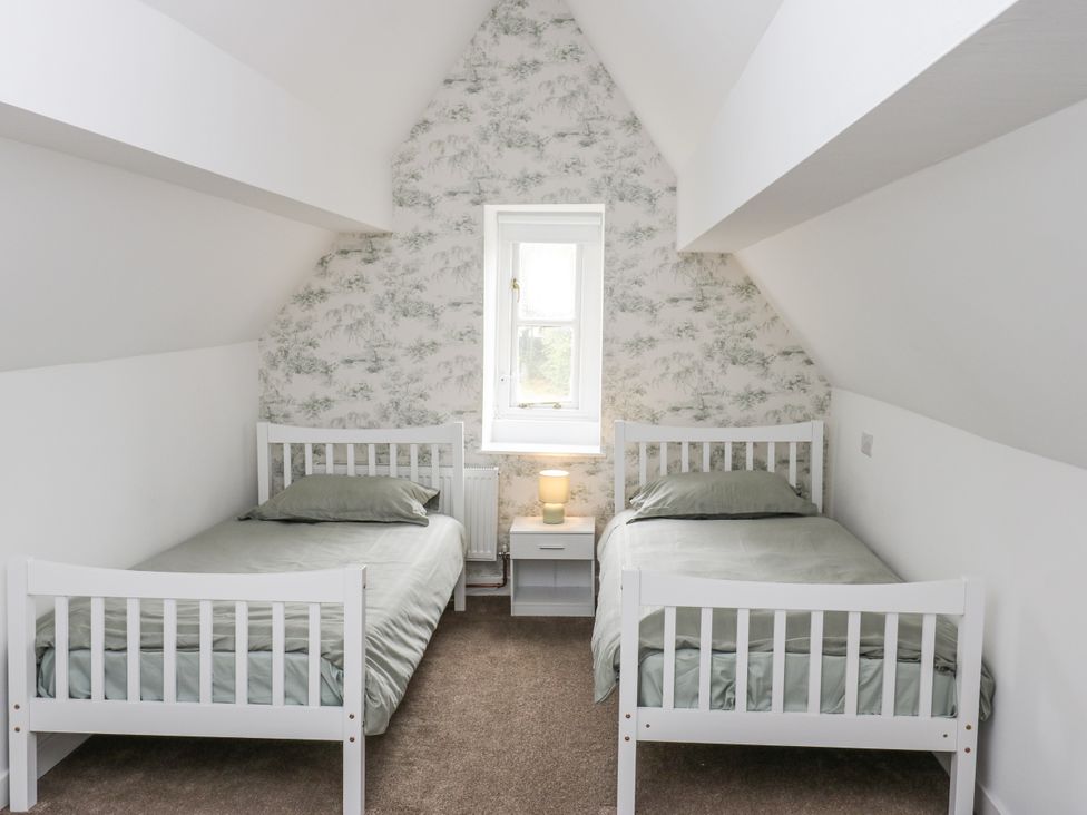 A bedroom with two beds and a window at Cold Spring House in Cullingworth