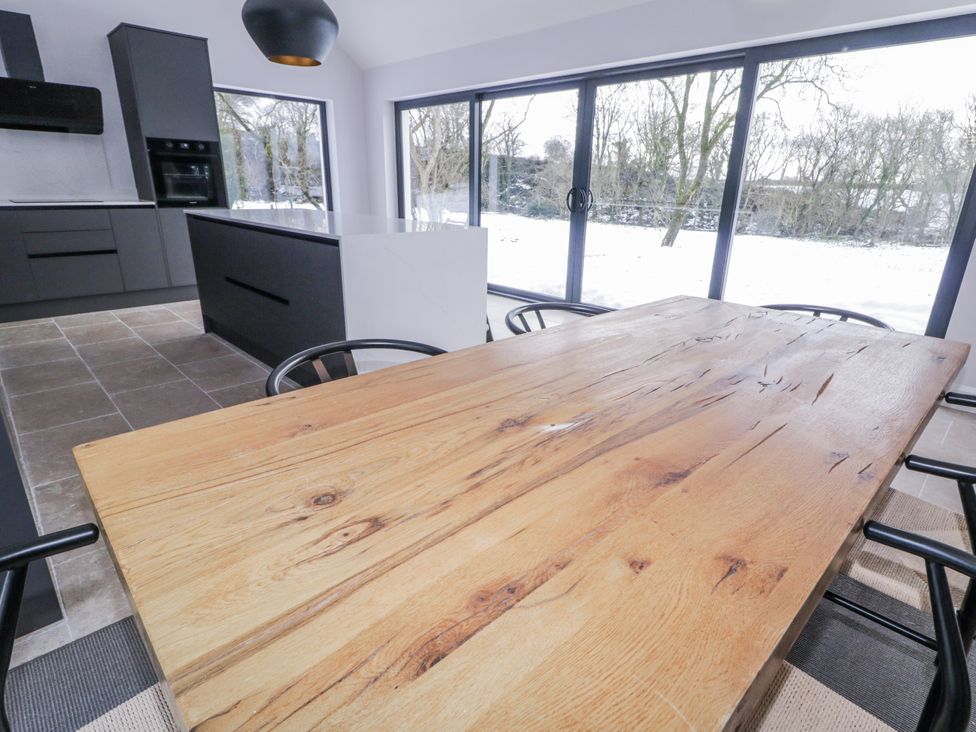 A kitchen with wooden table and chairs at Cloneytrace Mines in 