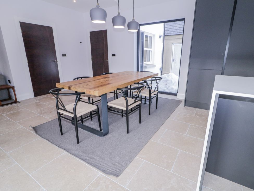 A dining room with a table and chairs at Cloneytrace Mines