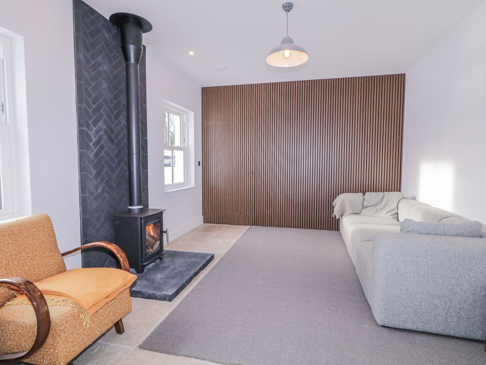 A living room with a fireplace and seating arrangements at Cloneytrace Mines