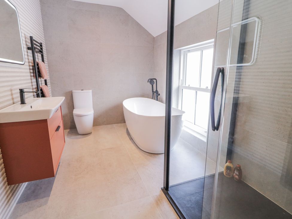 A bathroom featuring a bathtub, toilet, sink, and shower at Cloneytrace Mines
