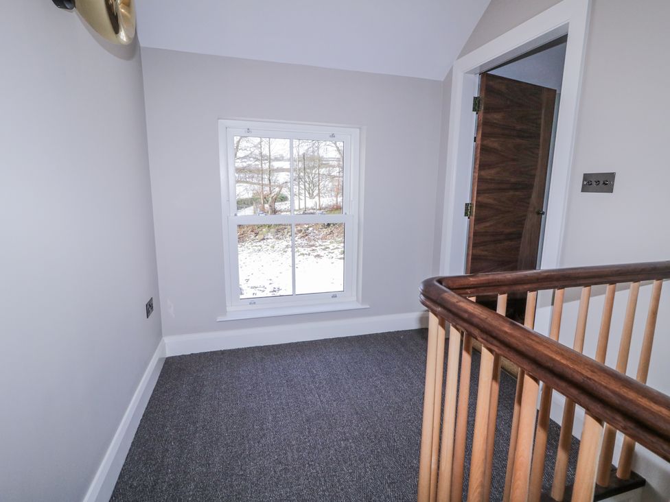 A hallway with a window and door at Cloneytrace Mines