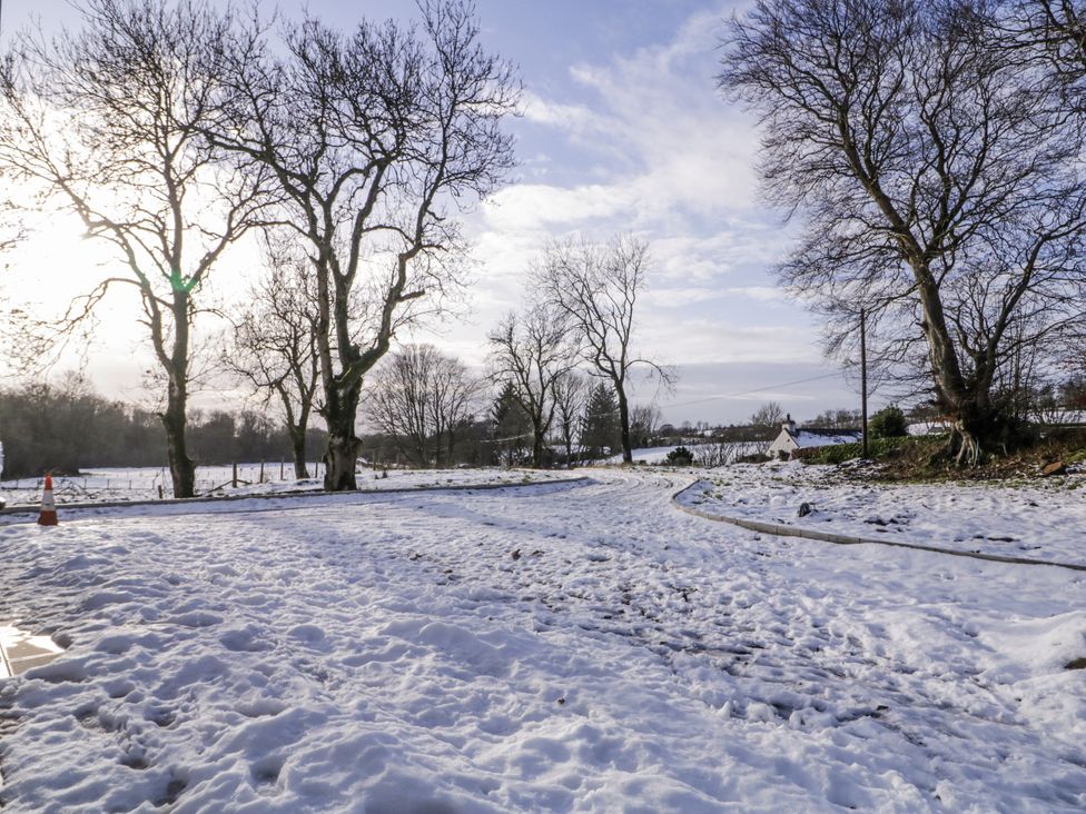 A snowy landscape with trees and a winding road at Cloneytrace Mines 