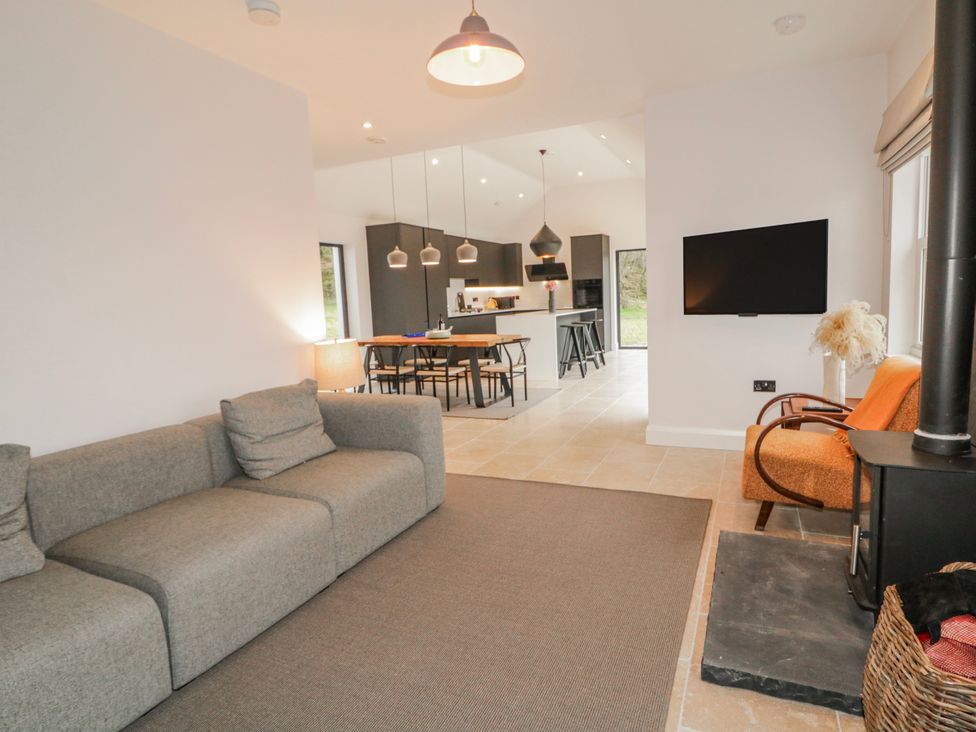 A living room with a sofa and television at Cloneytrace Mines Broughshane