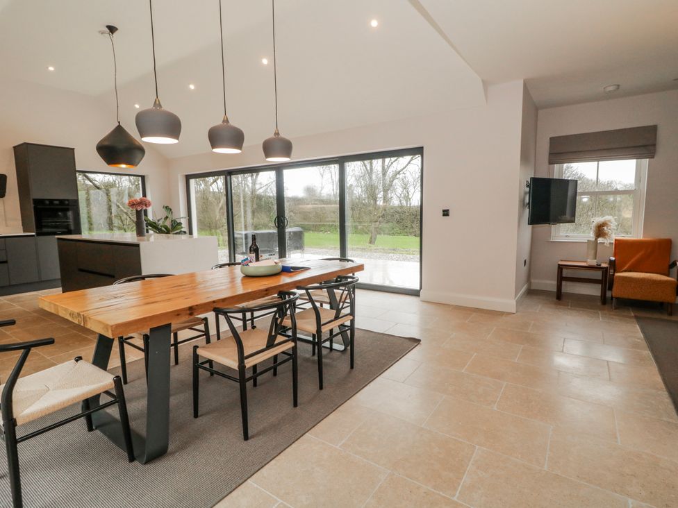 A dining room with a table and chairs at Cloneytrace Mines Broughshane