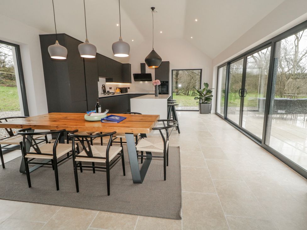 A kitchen with a dining table and chairs at Cloneytrace Mines Broughshane