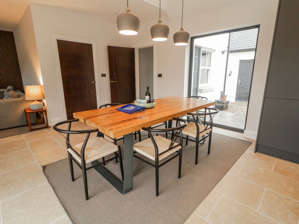 A dining room with a table and chairs at Cloneytrace Mines in Broughshane