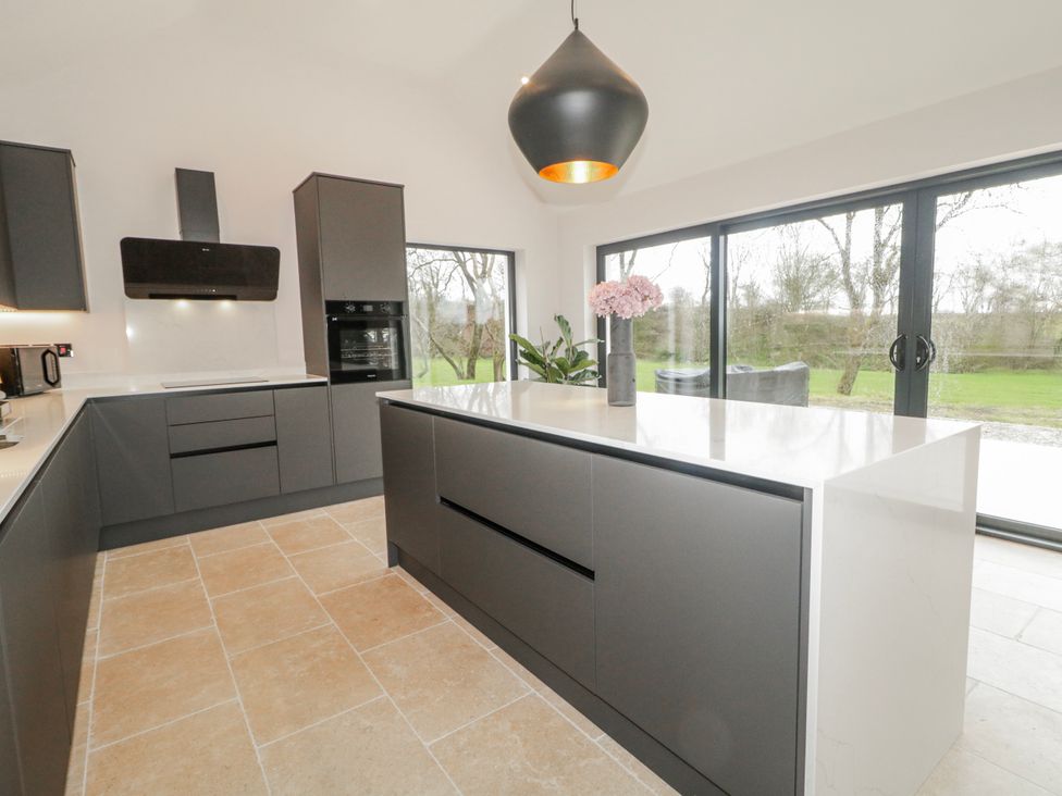 A kitchen with a large countertop and modern appliances at Cloneytrace Mines in Broughshane