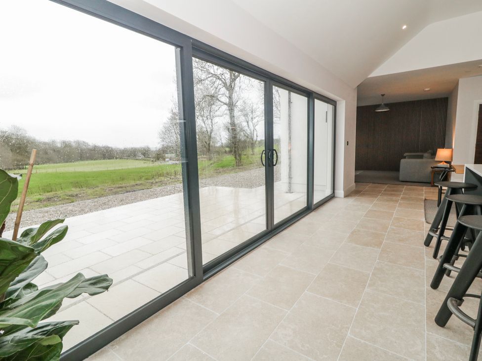 A room with glass doors and a view of the outdoors at Cloneytrace Mines in Broughshane