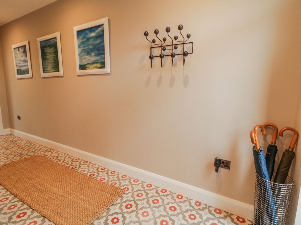 A hallway with paintings and an umbrella stand at Cloneytrace Mines, Broughshane