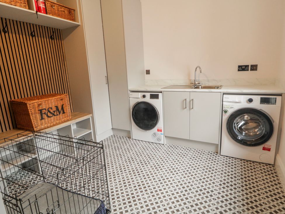 A laundry room with a washing machine and dryer at Cloneytrace Mines Broughshane
