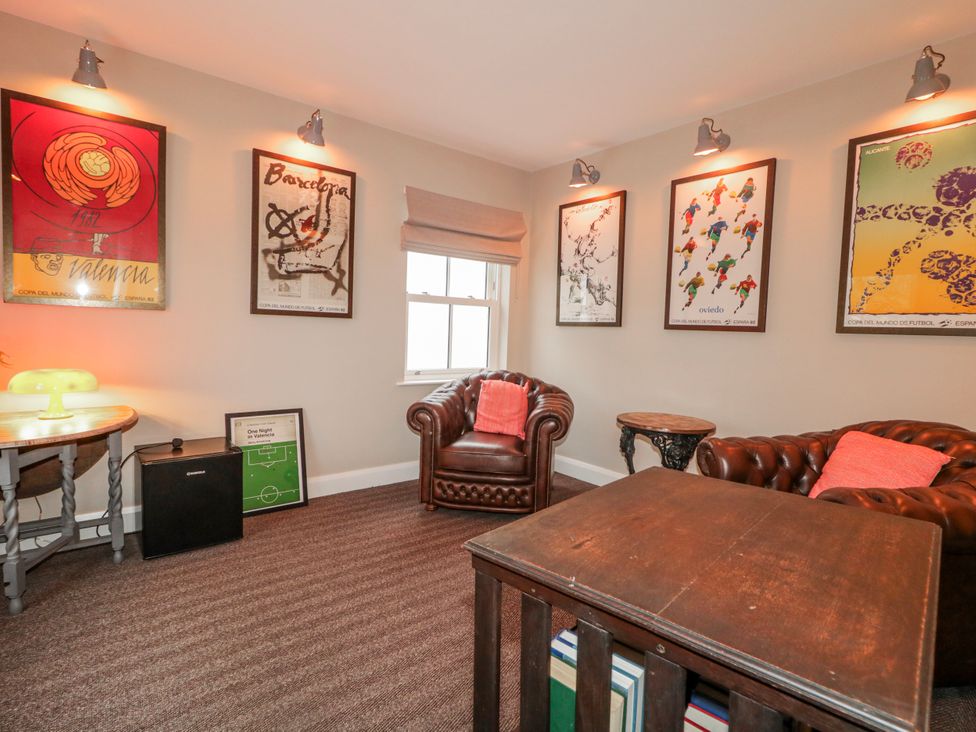 A sitting room with armchairs and artwork at Cloneytrace Mines in Broughshane