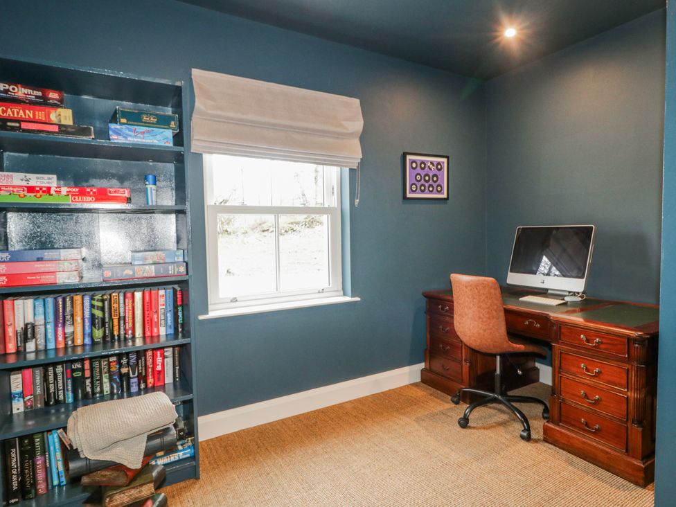 An office with a computer and bookshelf at Cloneytrace Mines in Broughshane