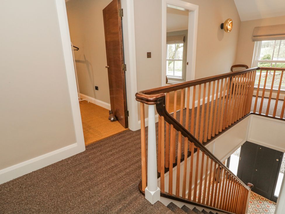 A hallway with stairs and a door at Cloneytrace Mines Broughshane