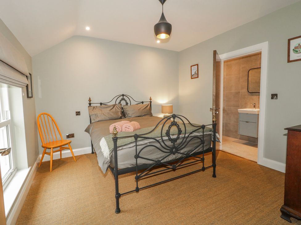 A bedroom with a bed and a chair at Cloneytrace Mines in Broughshane