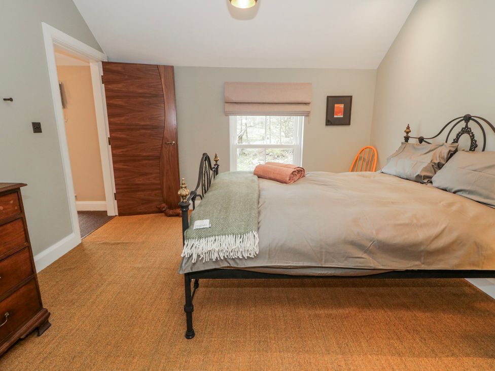 A bedroom with a bed and dresser at Cloneytrace Mines, Broughshane