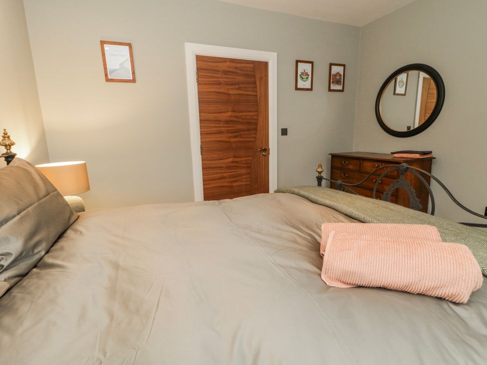 A bedroom with bed and mirror at Cloneytrace Mines Broughshane