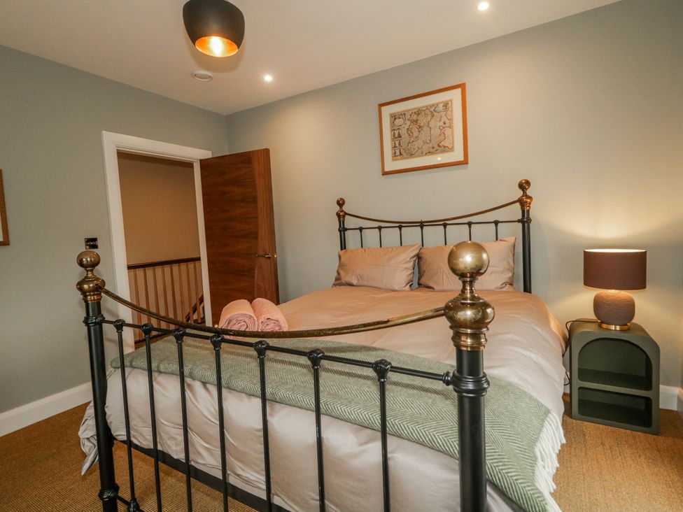 A bedroom with a double bed and bedside table at Cloneytrace Mines in Broughshane