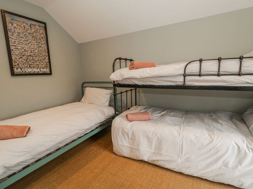 A bunk bed and a single bed in a bedroom at Cloneytrace Mines Broughshane