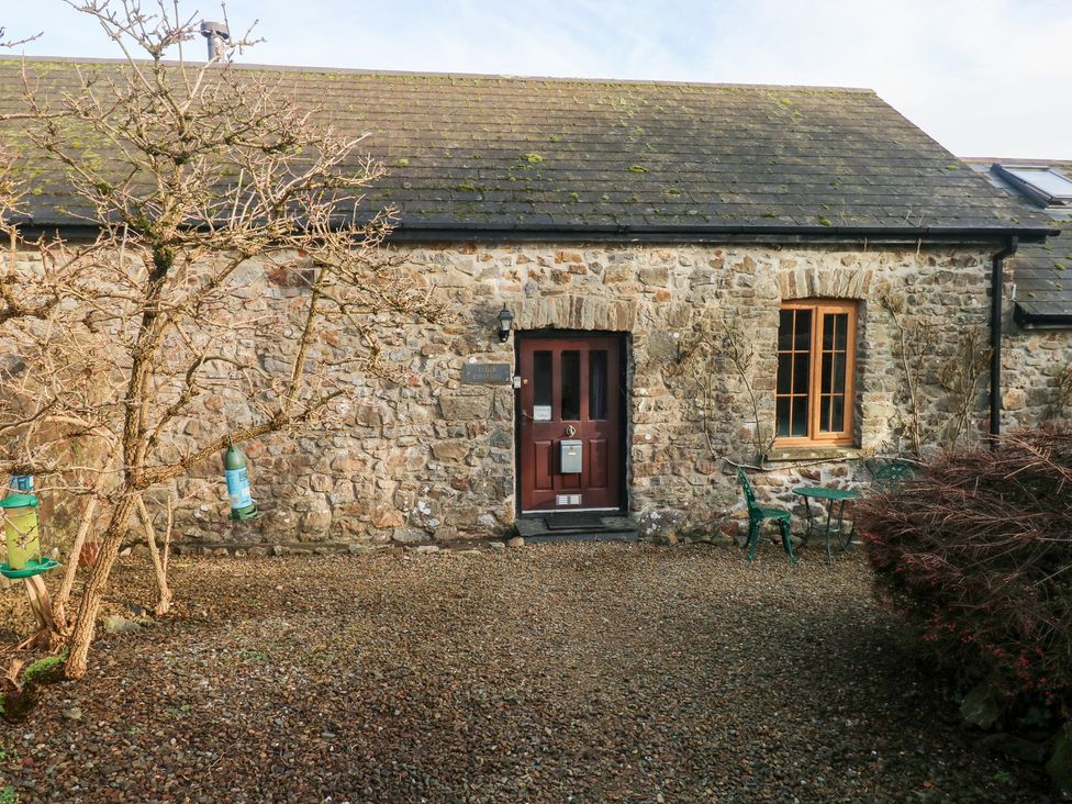 A stone cottage exterior with a door and windows at 8 Rogeston Cottages Haverfordwest