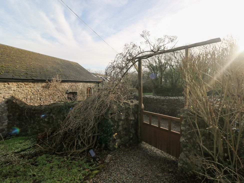 An outdoor area with a gate and stone wall at 8 Rogeston Cottages in Haverfordwest