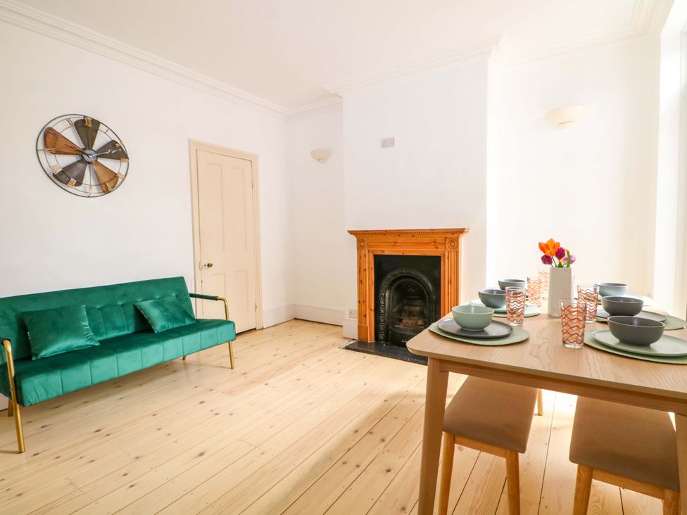 A dining room with a table set for meal at 70 High Street in Canterbury