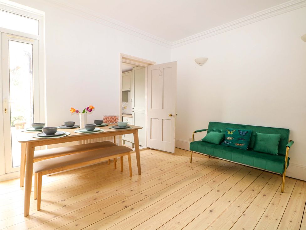 A dining room with a wooden table and chairs at 70 High Street in Canterbury