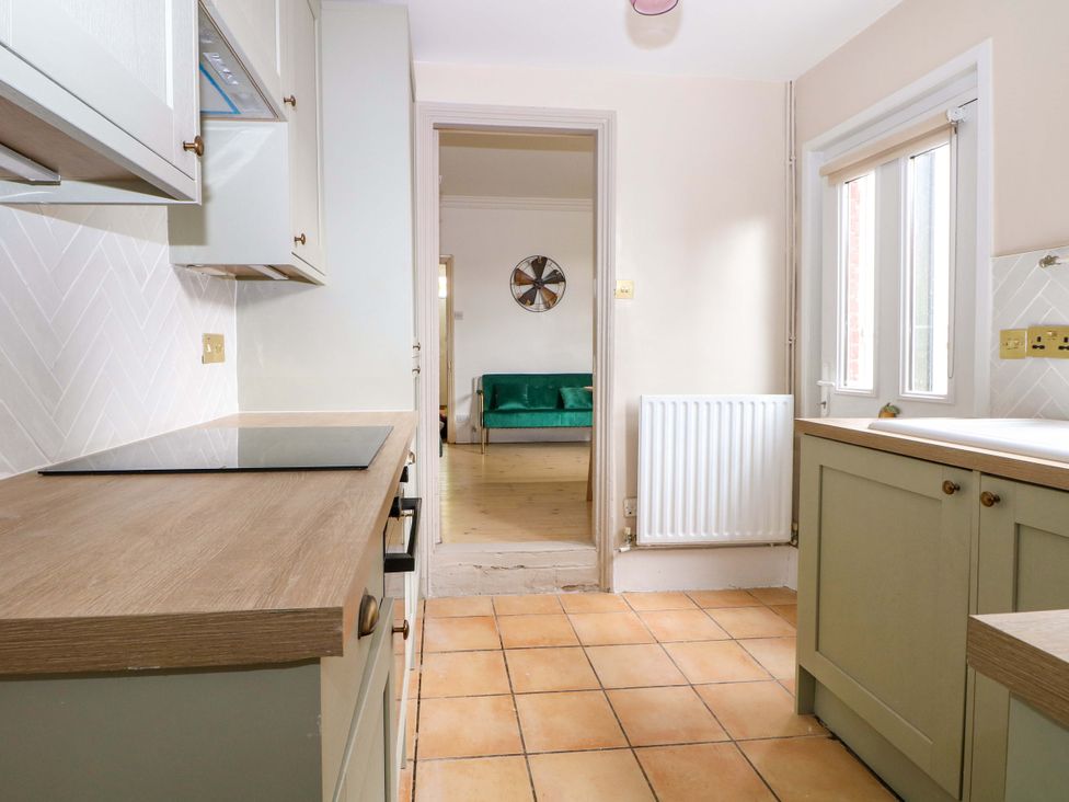 A kitchen with cabinets and a stove at 70 High Street, Canterbury