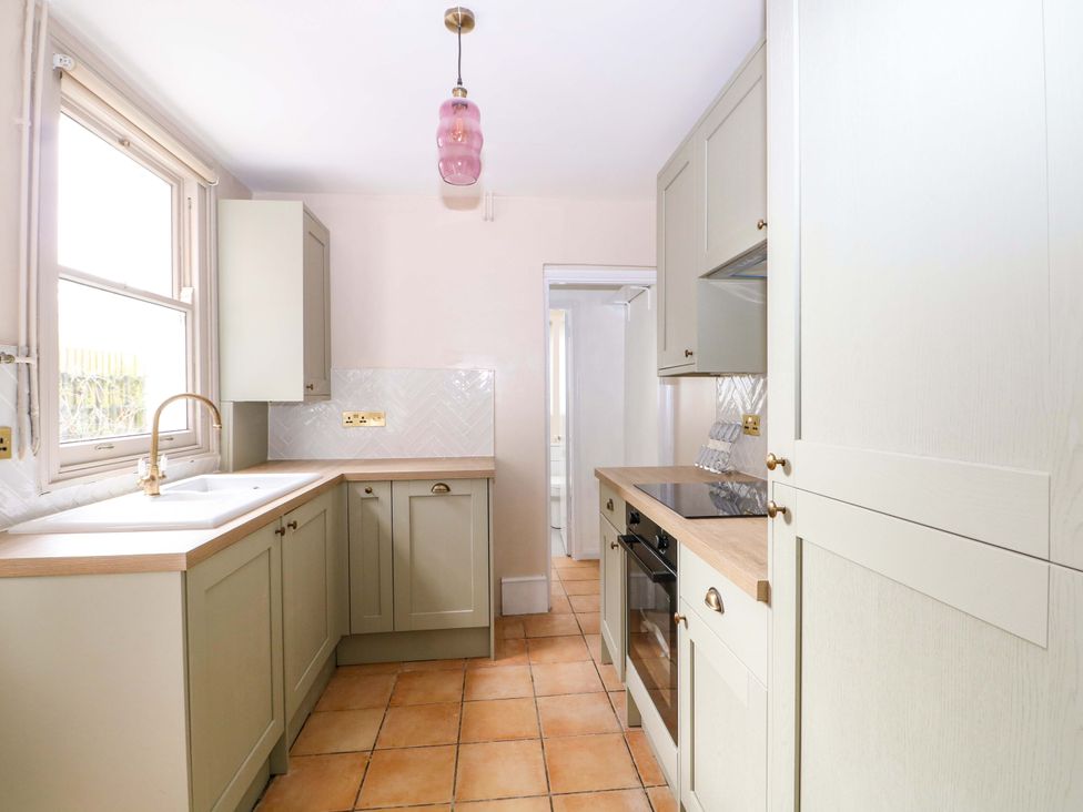 A kitchen with cabinets and appliances at 70 High Street, Canterbury