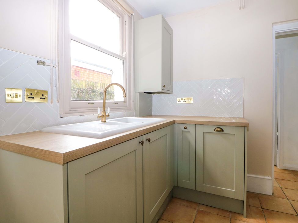 A kitchen with a sink and cabinets at 70 High Street, Canterbury