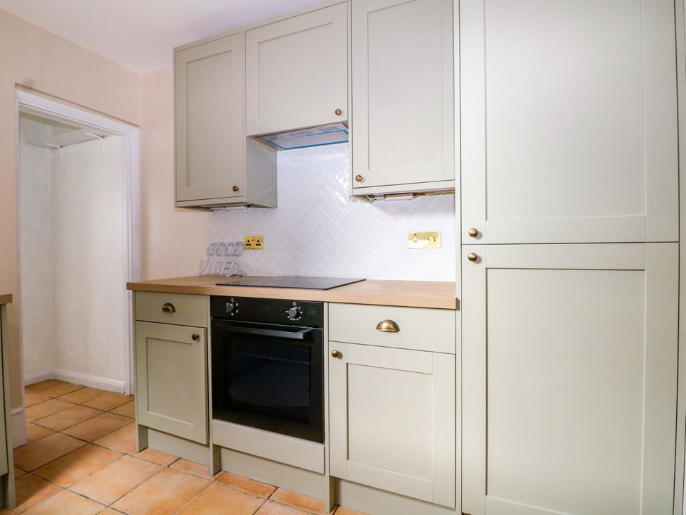 A kitchen with cabinets and an oven at 70 High Street in Canterbury
