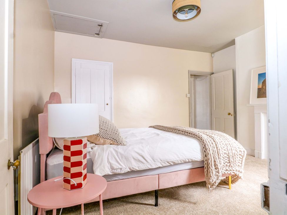 A bedroom with a bed and bedside lamp at 70 High Street, Canterbury