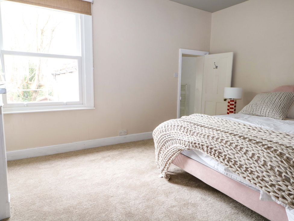 A bedroom with a bed and a window at 70 High Street in Canterbury