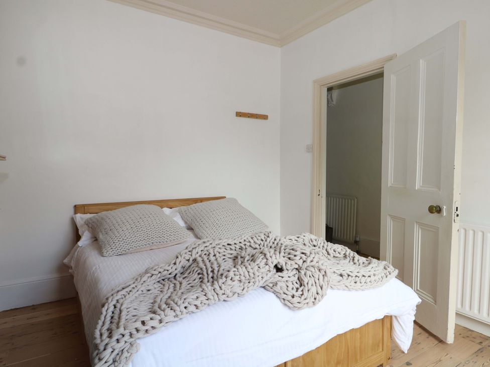 A bedroom with a bed and a door leading to another area at 70 High Street, Canterbury