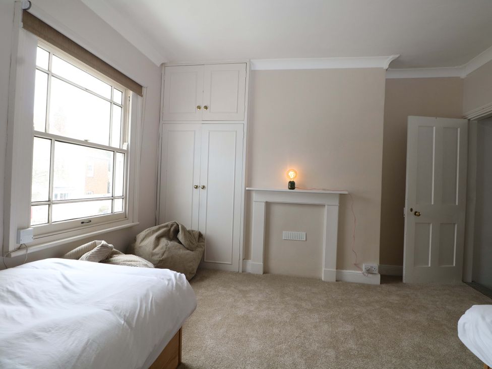 A bedroom with a bed and a window at 70 High Street in Canterbury